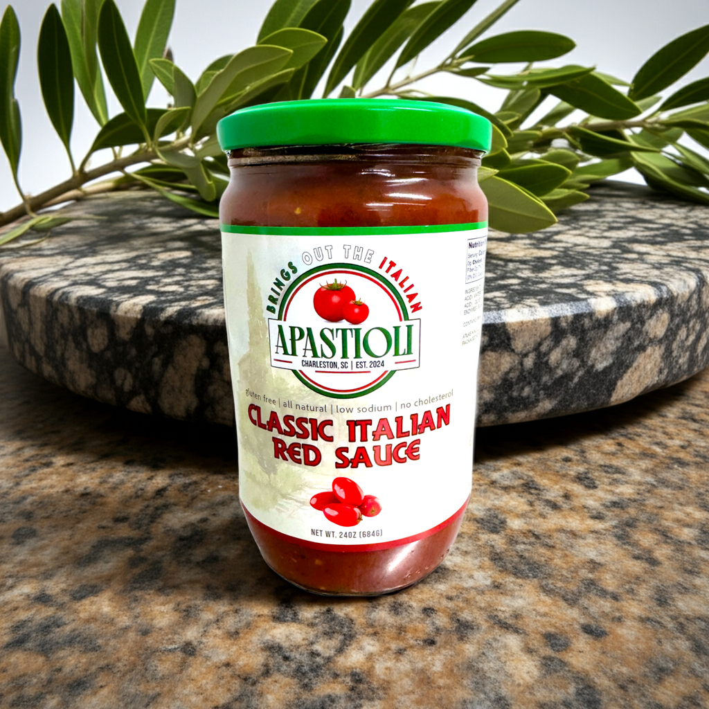 Jar of Apastioli Classic Italian Red Sauce on a marble surface with olive branches in the background